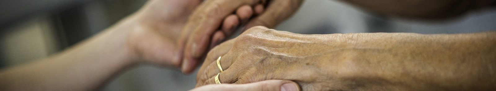 nurse hand and senior patient's hand holding each other